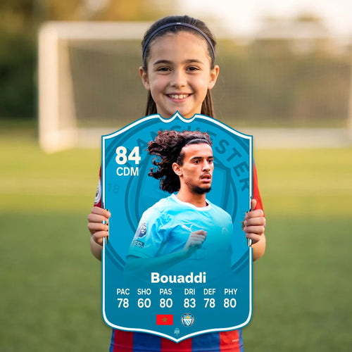 Kid holding the Ayyoub Bouaddi Manchester City FC27 football card