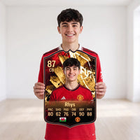 Welsh teenager in a Manchester United shirt holding his FC27 Hall of Fame personalised card