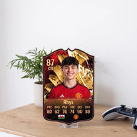 Red and gold FC27 Hall of Fame card on a transparent stand, a desk keepsake for a football milestone