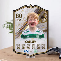 White and gold FC27 Icon custom card on an acrylic display stand on a light wood desk